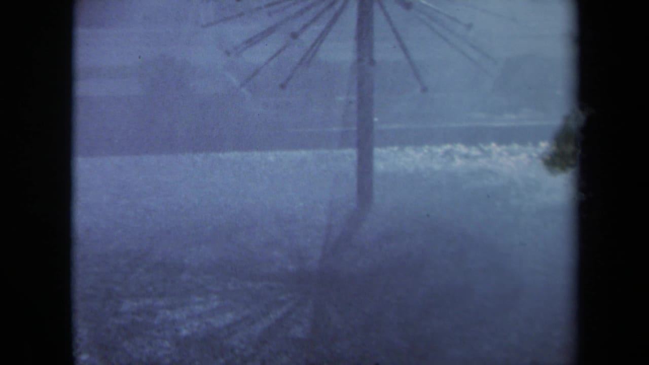 1969 Sacramento 8mm frame showing a misty, rain-softened view of a spiky radial structure against a bluish background.