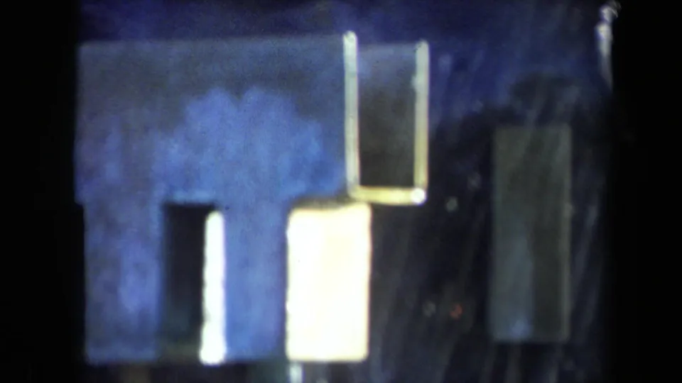 1969 Sacramento 8mm frame showing blue-toned metal surfaces, bright reflections, and soft film texture.
