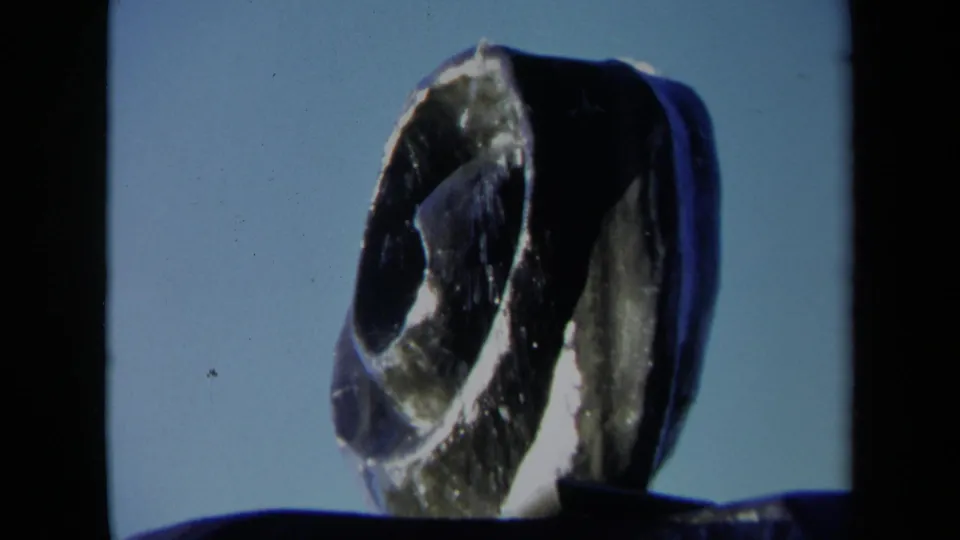 Close 8mm frame of the Sacramento abstract fountain showing the textured spiral form and dark basin edge in strong contrast.