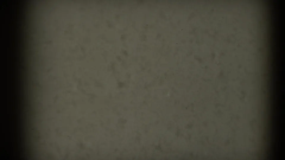1969 Sacramento 8mm footage shows an end-of-reel film surface with grain, dust, black edge shadow, and no visible subject.