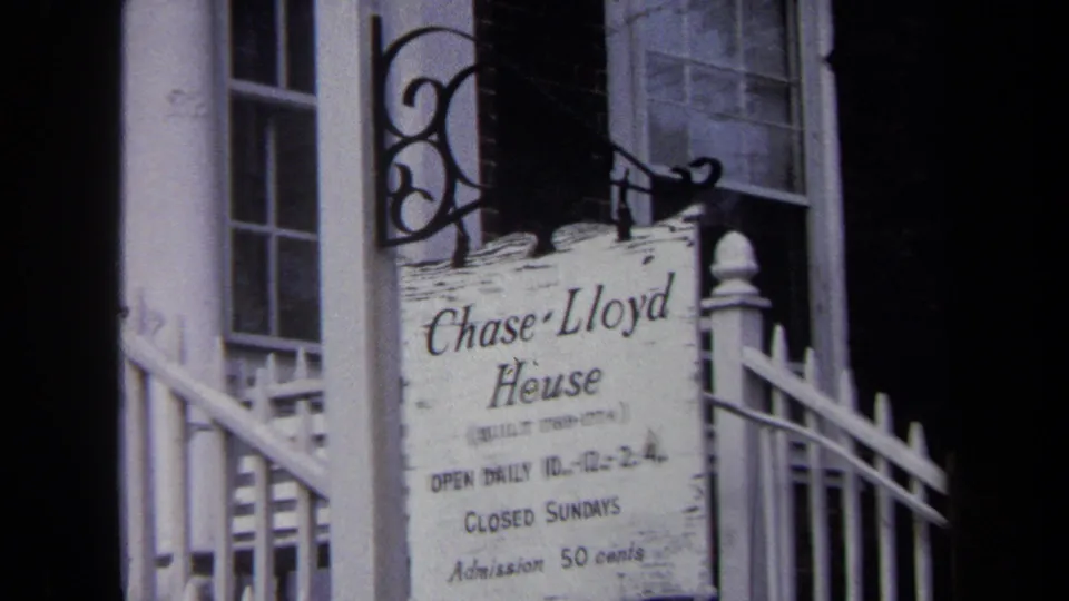 Tight Annapolis frame of the Chase Lloyd House sign, with hours, Sunday closure, and 50-cent admission partly legible.