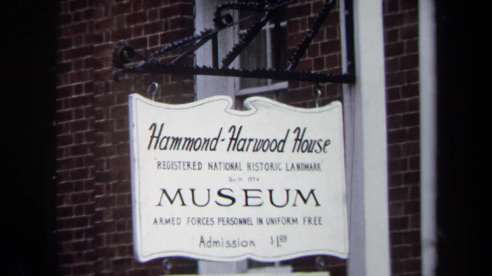 Close view of the Hammond-Harwood House Museum sign naming it a registered National Historic Landmark, with admission text below.