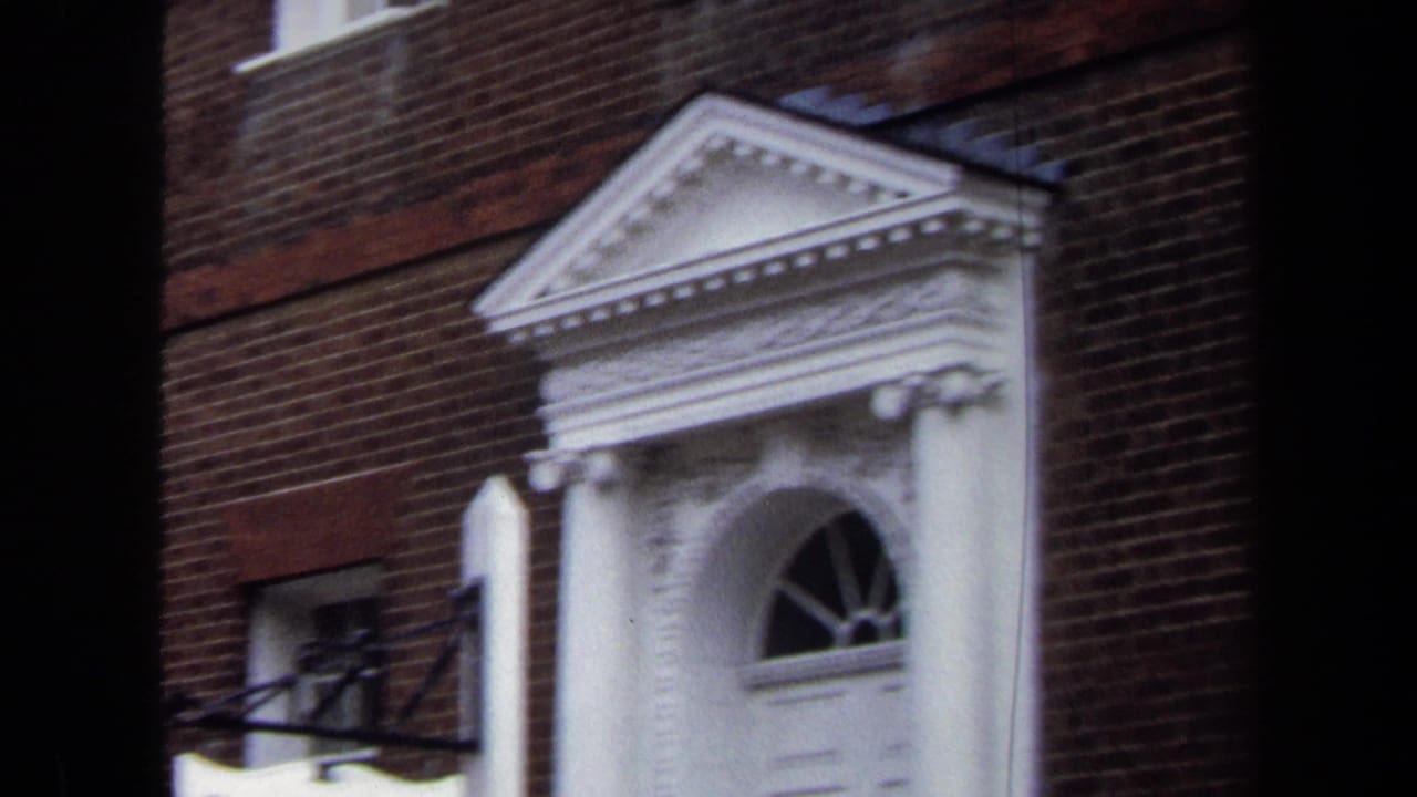 1970 Annapolis frame of the Hammond-Harwood House entrance with a white pediment, columns, arched fanlight, and red brick wall.