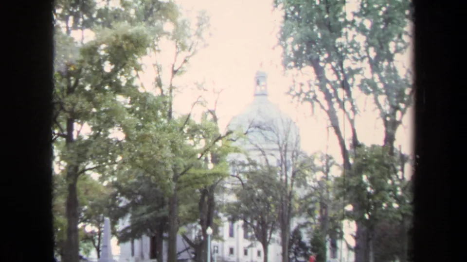 A similar 1970 Annapolis view shows the dome behind trees, with the film frame split by dark window-like edges.