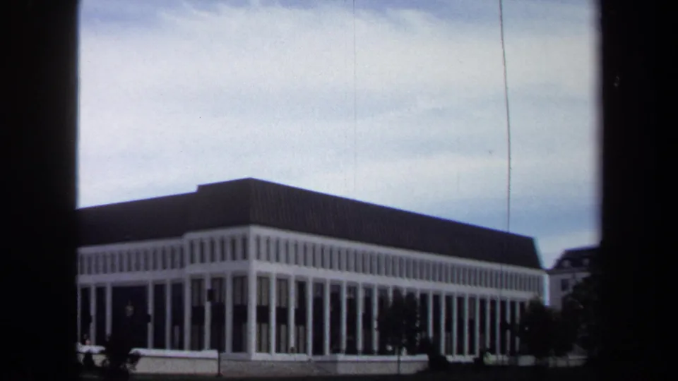 Annapolis 1970 8mm frame of a modernist colonnade and adjacent building, divided by dark window framing.