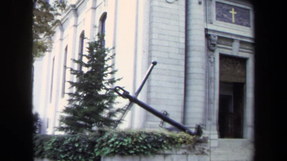 Annapolis 1970 exterior detail of an anchor monument near a stone doorway, with a cross visible above the entrance.