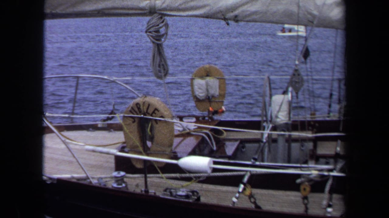 1970 Annapolis sailboat deck view showing the JUBILEE life ring, railings, ropes, rigging, and water under a canvas edge.