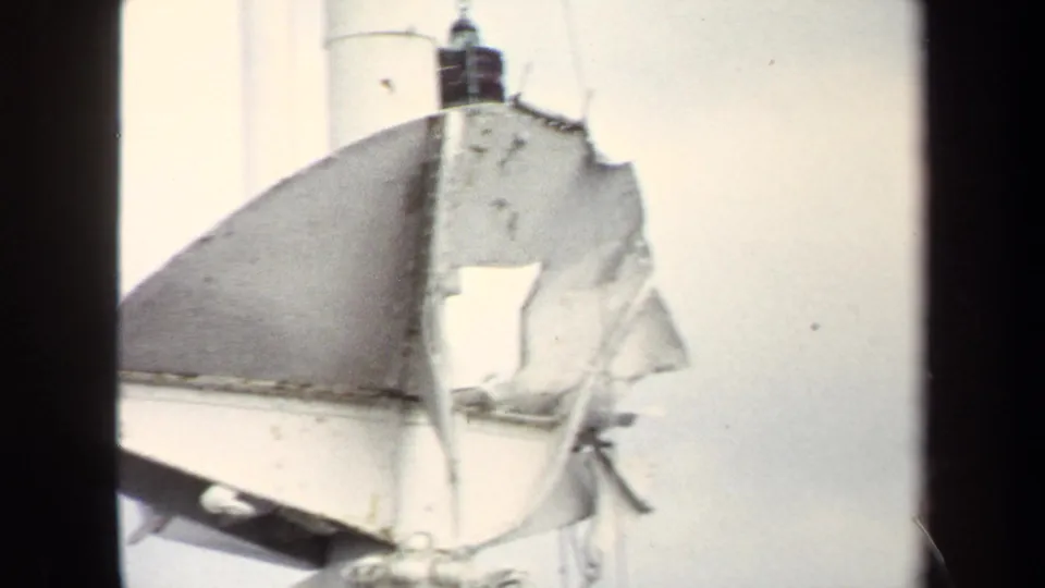 The final 1970 Annapolis frame is brighter and washed out, but still shows the torn hanging object, pole, and sky.