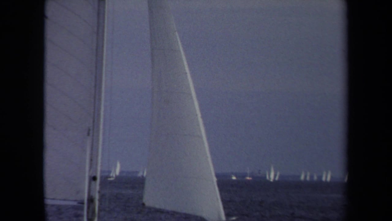 A 1970 Annapolis sailboat view shows nearby sails in the foreground and small white sails across the water.