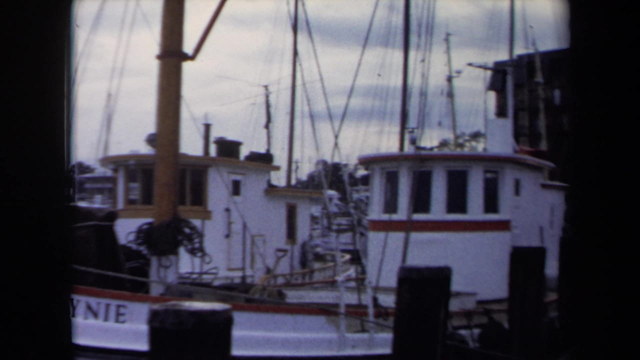 1970 Annapolis marina frame showing a white vessel, rigging, dock post, and partial lettering on the hull.