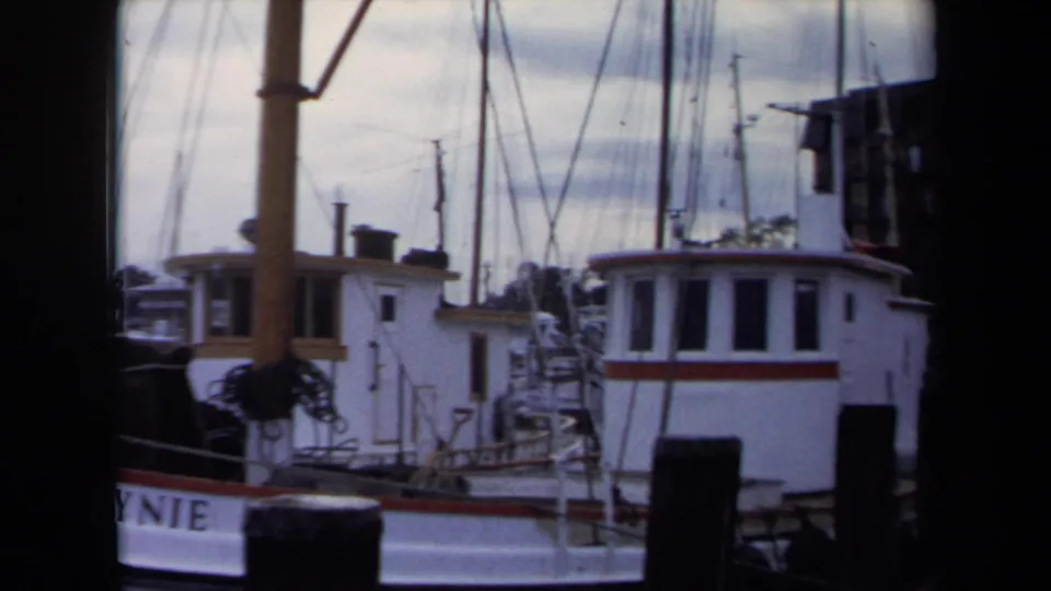 1970 Annapolis marina frame showing a white vessel, rigging, dock post, and partial lettering on the hull.