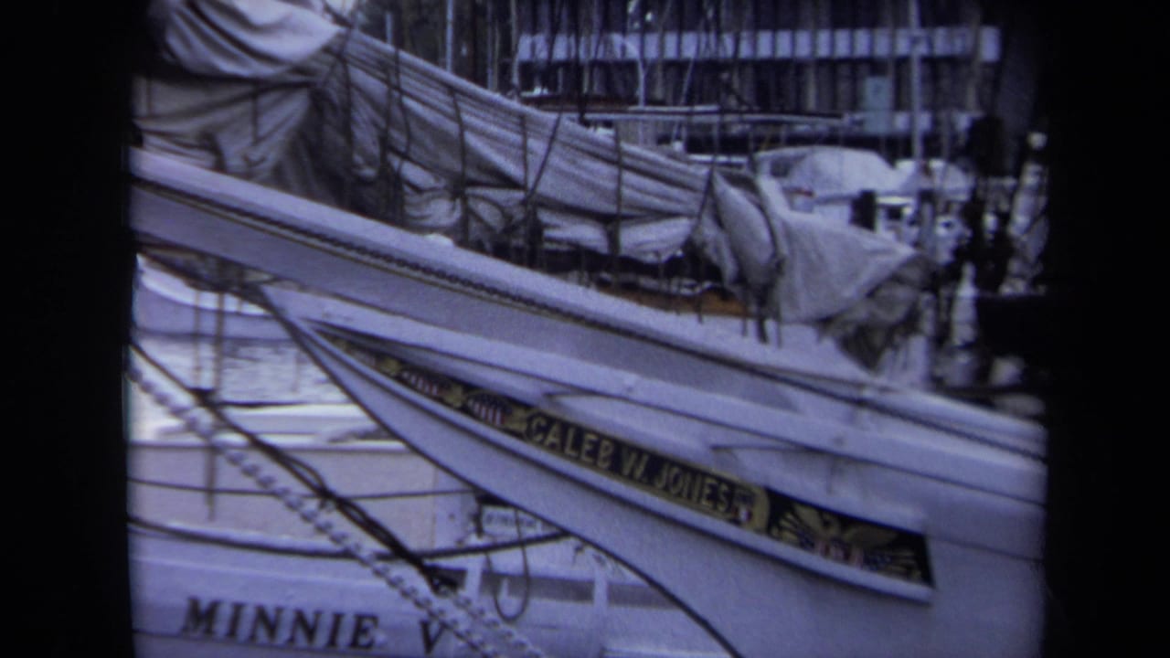 1970 Annapolis marina footage shows a close, slightly soft view of sailboat rigging, covered gear, and visible Caleb W. Jones and Minnie V. boat names.