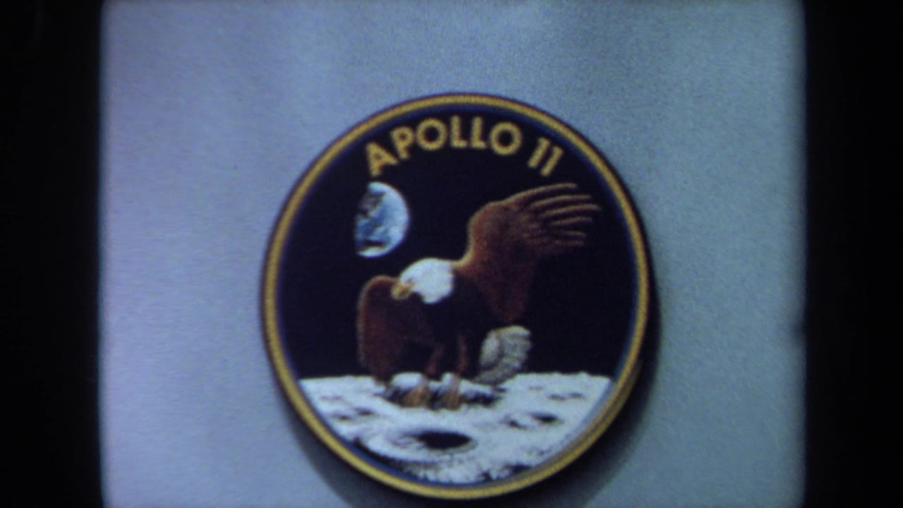Apollo 11 patch centered in frame with eagle artwork and moon surface detail.