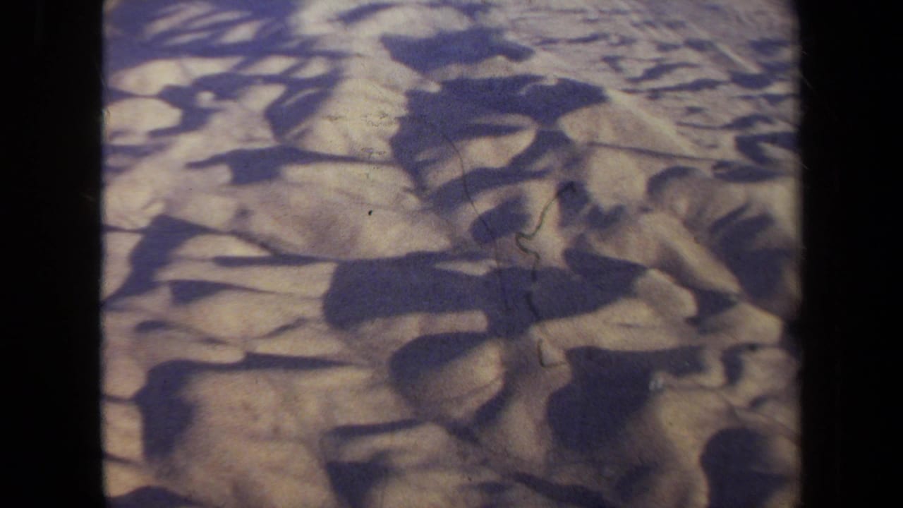 1970 California 8mm aerial footage appears to show arid desert terrain with strong shadows and visible film gate edges.