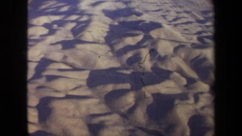 1970 California 8mm aerial footage appears to show arid desert terrain with strong shadows and visible film gate edges.