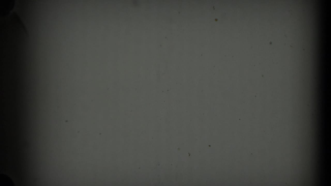 Blank 8mm leader or unexposed frame area appears after the aerial footage, with dark gate edges and dust marks.