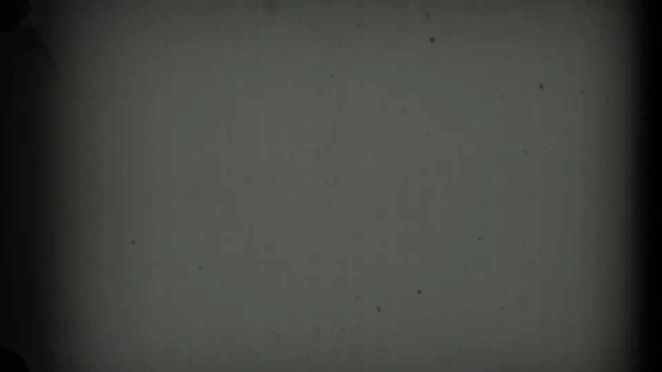 Blank 8mm leader or unexposed frame area appears after the aerial footage, with dark gate edges and dust marks.