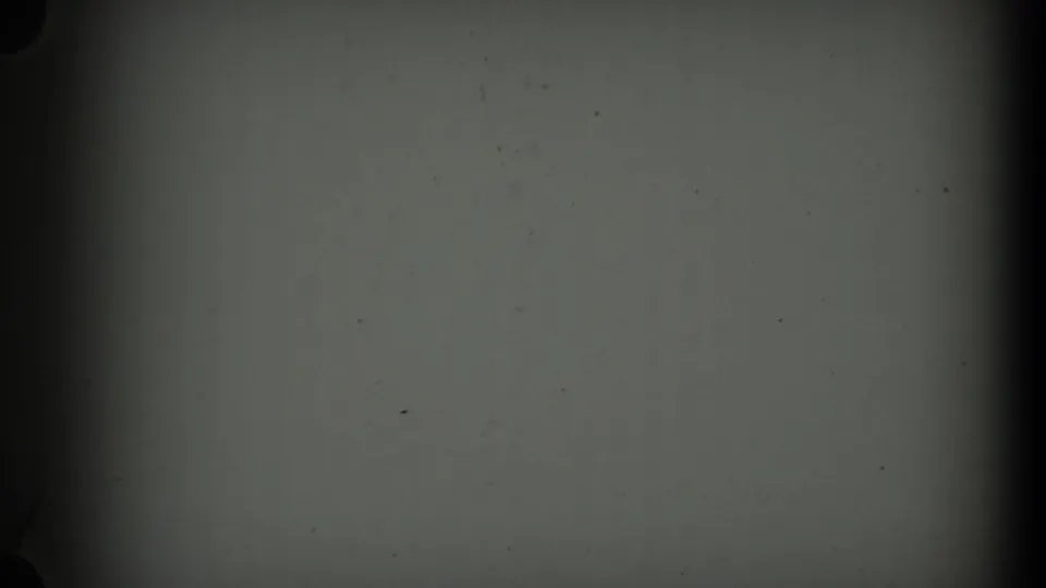 The final frame shows mostly blank 8mm leader with dark gate edges, faint scratches, and scattered dust specks.