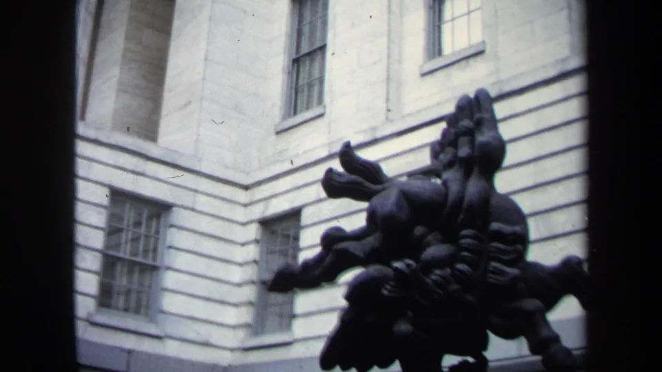 1970 Washington, DC visitor-shot frame of a pale neoclassical facade with sash windows and a dark rearing-horse sculpture in the foreground.