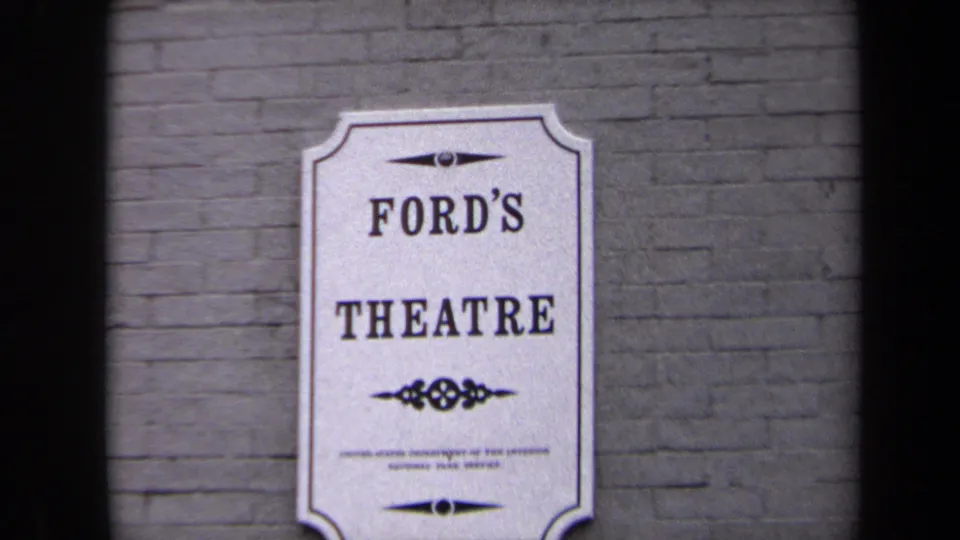 Close 1970 8mm view of the Ford's Theatre sign in Washington DC against brick masonry.
