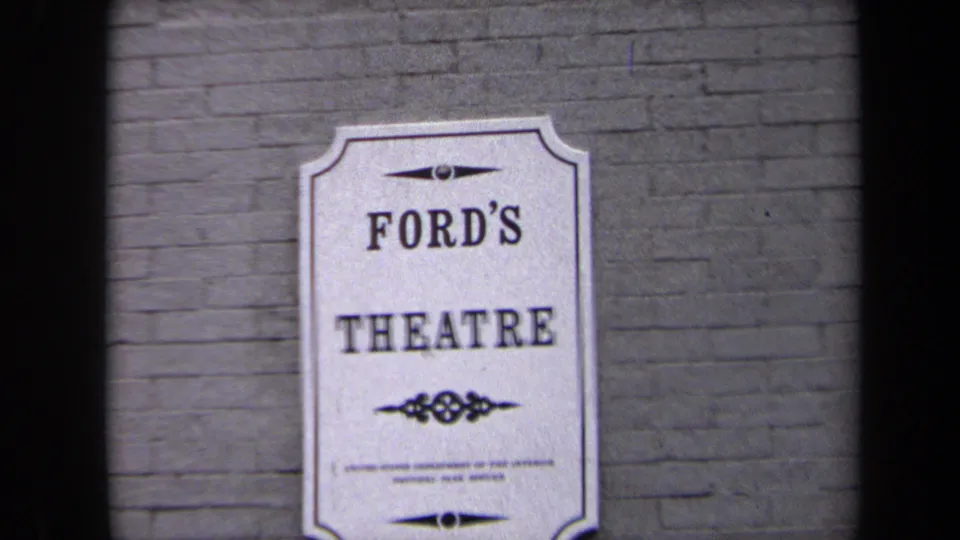 1970 Washington DC 8mm frame showing a Ford's Theatre sign on brick, split by dark contact-sheet frame bars.