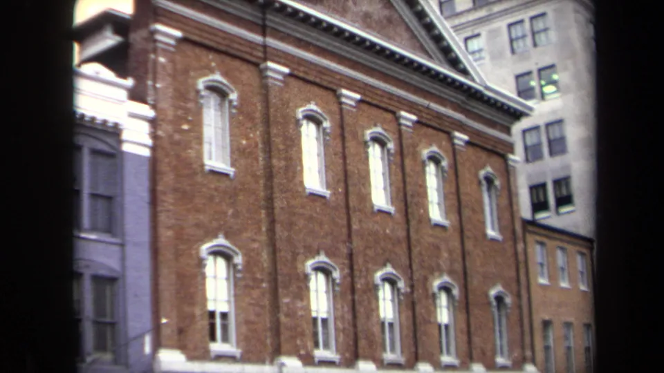 1970 Washington, DC frame showing Ford's Theatre exterior more fully, with rows of arched windows and taller buildings behind and beside it.