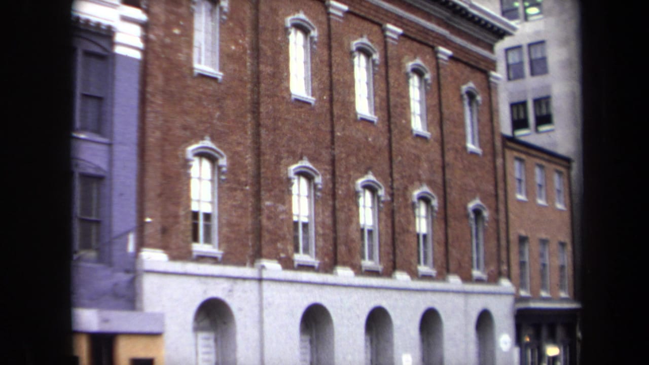 1970 Washington, DC frame of a brick building exterior with pale arched ground-floor bays and rows of narrow windows.