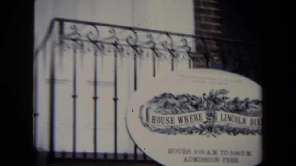 1970 Washington, DC frame showing a partial oval House Where Lincoln Died sign below wrought iron railing and steps.