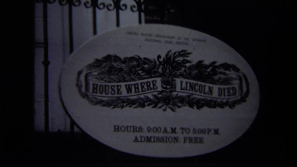 Darker 1970 Washington, DC frame showing the House Where Lincoln Died sign, posted hours, and iron fence detail.