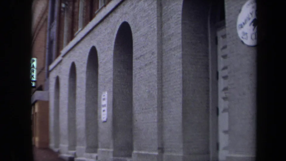 1970 Washington, DC frame of the arched brick exterior, with a vertical PARK sign visible down the street.