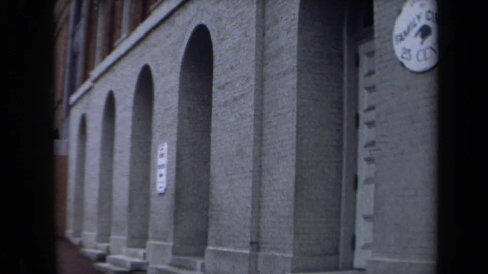 1970 Washington, DC home-movie view of repeated arched openings along the brick theatre frontage.