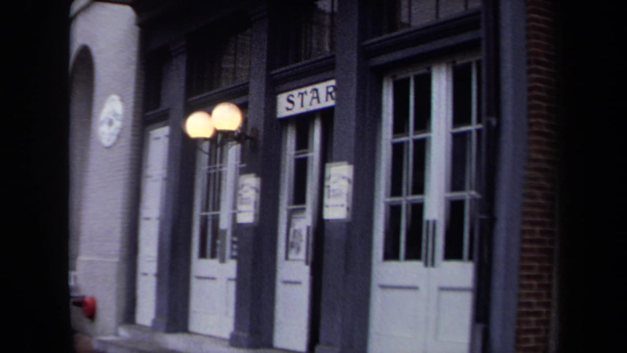 1970 Washington, DC frame with white double doors, dark trim, globe lamps, posters, and a visible sign reading "STAR" above an entrance.