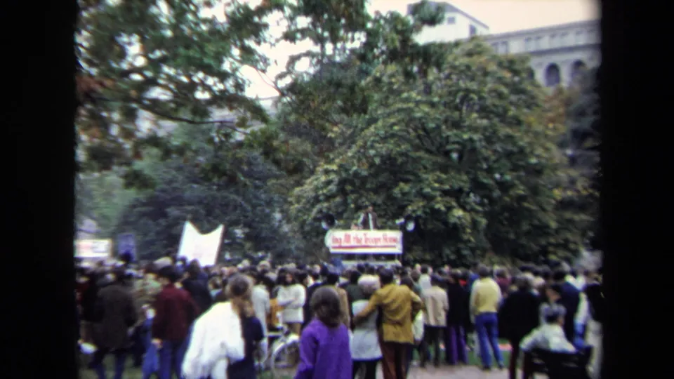 1970 Washington, DC park protest with a crowd facing signs, including a banner that appears to read Bring All the Troops Home.