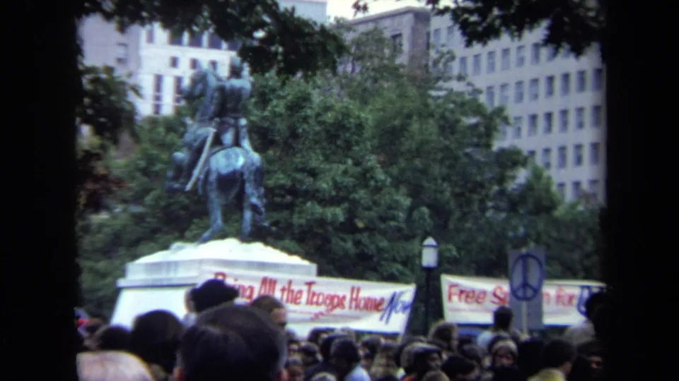 Washington, DC rally footage frames an equestrian statue, crowd, banners, trees, and nearby buildings during the 1970 gathering.