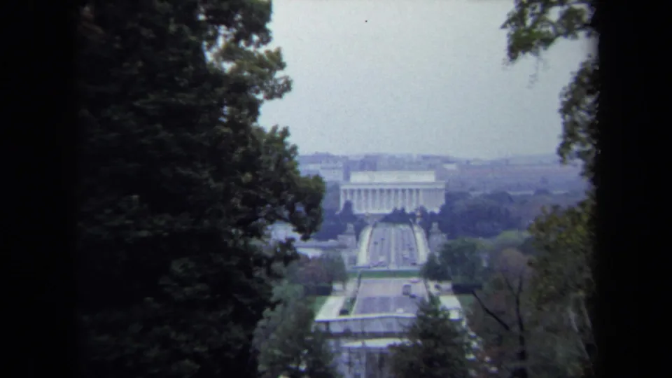 1970 Washington DC home-movie still showing a closer zoom on the Lincoln Memorial and Reflecting Pool from a wooded overlook.