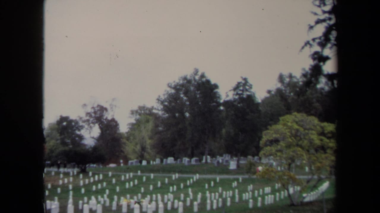 1970 Washington, DC 8mm view of white military headstones spread across a grassy cemetery under overcast light.