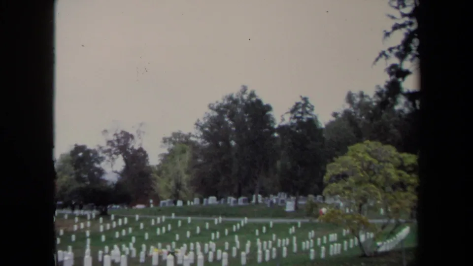 1970 Washington, DC 8mm view of white military headstones spread across a grassy cemetery under overcast light.