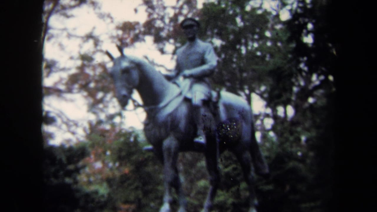 1970 Washington DC 8mm frame showing a bronze equestrian memorial statue surrounded by trees.
