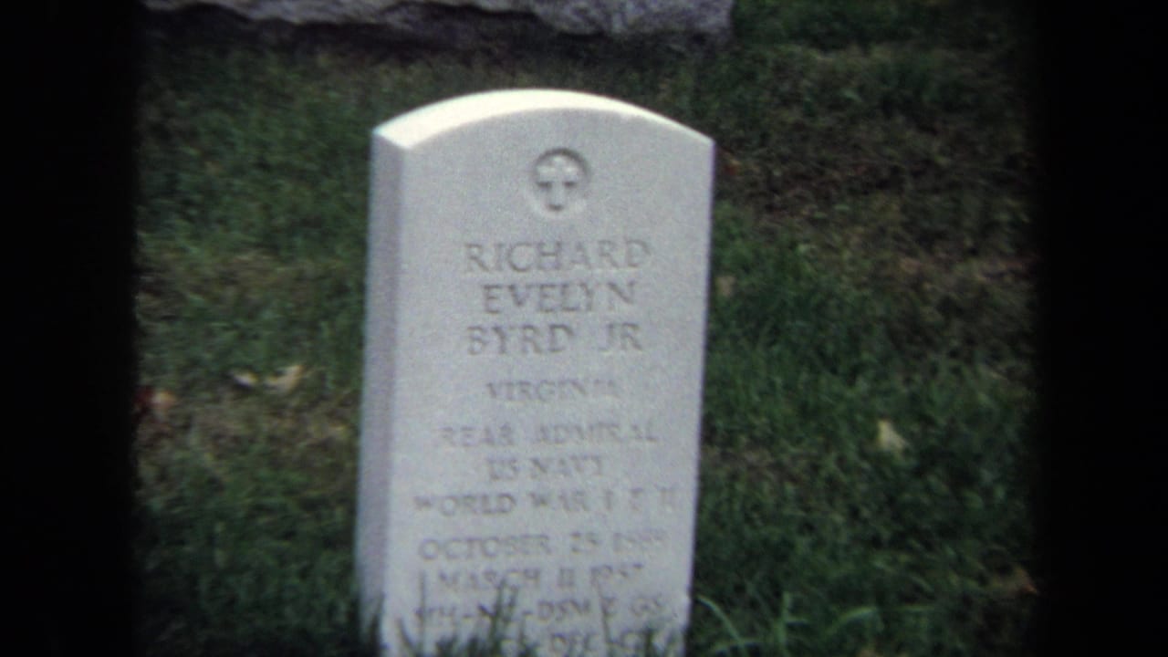 1970 Washington DC 8mm frame showing Richard Evelyn Byrd Jr.'s military gravestone surrounded by grass and dark film borders.