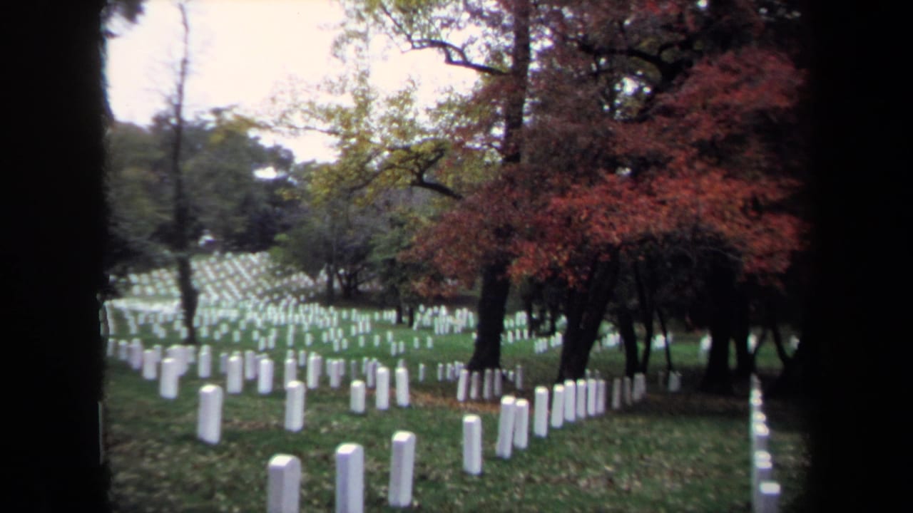 1970 Washington, DC cemetery view with rows of white headstones, grass, and trees showing red and yellow autumn foliage.