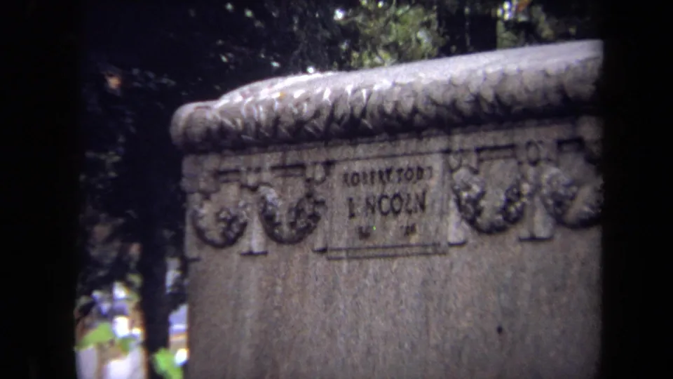 Close 8mm view of a decorated cemetery marker where the Robert Todd Lincoln inscription is visible.