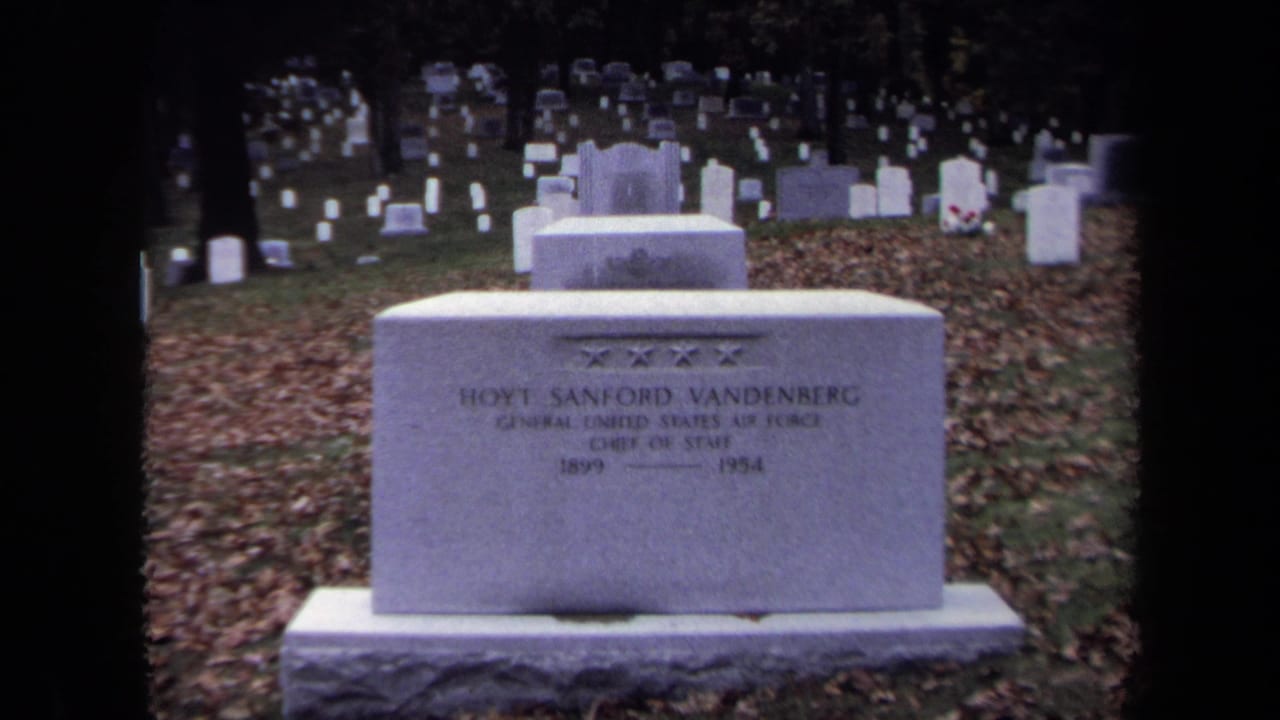 White grave marker for Hoyt Sanford Vandenberg in a cemetery with fallen leaves.