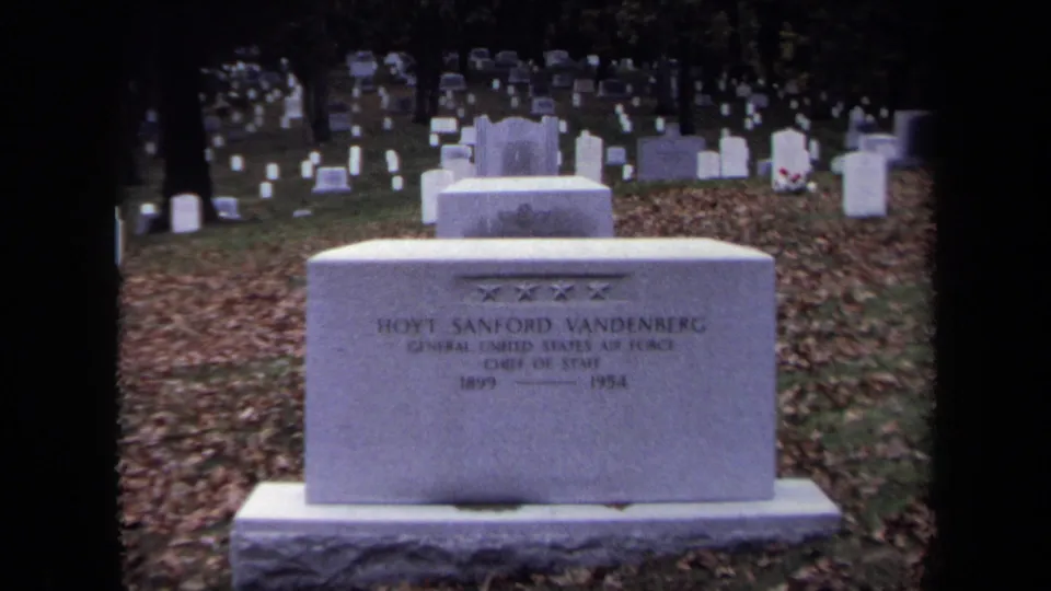 1970 Washington DC 8mm frame showing the Hoyt Sanford Vandenberg headstone among white cemetery markers and autumn leaves.