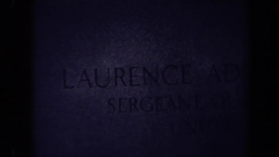 Dark 8mm frame from the 1970 Washington, DC cemetery clip, with part of Laurence Adolph Steinhardt's headstone faintly visible.