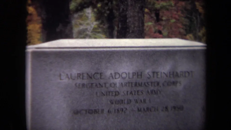 Close 8mm frame of the grave marker for Sergeant Laurence Adolph Steinhardt, with United States Army and World War I text visible.