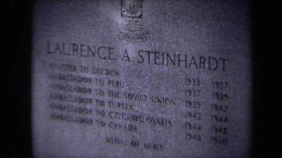 Close-up of the Laurence A. Steinhardt gravestone inscription in soft-focus 1970 Washington, DC 8mm footage.