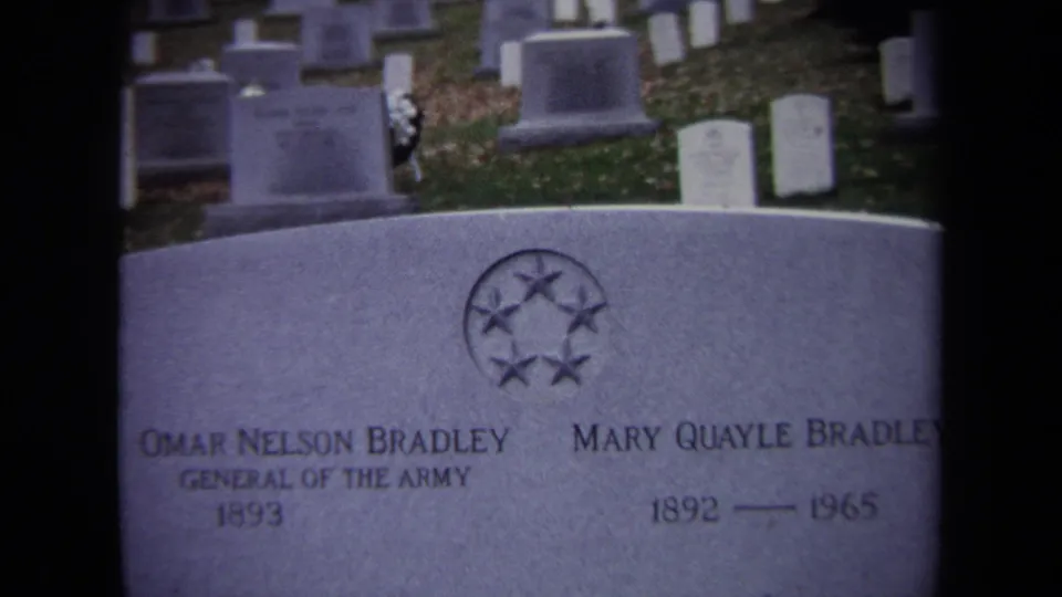 1970 8mm frame showing Omar Nelson Bradley and Mary Quayle Bradley's grave marker with uniform headstones in the background.