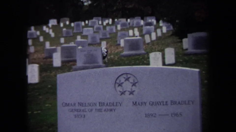 Wider Washington, DC cemetery view from 1970 showing the Bradley grave marker before rows of white military headstones.