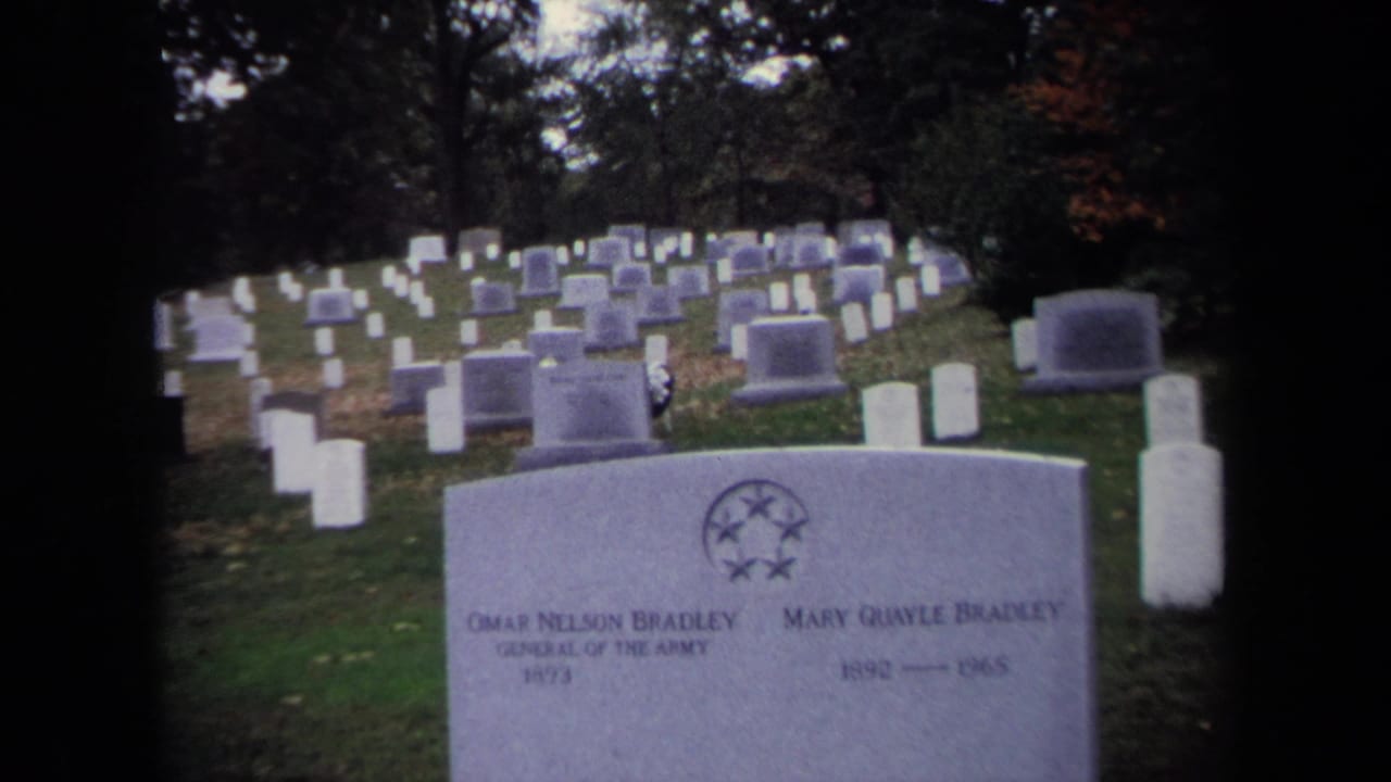 Rows of cemetery headstones with the Bradley grave marker in the foreground.