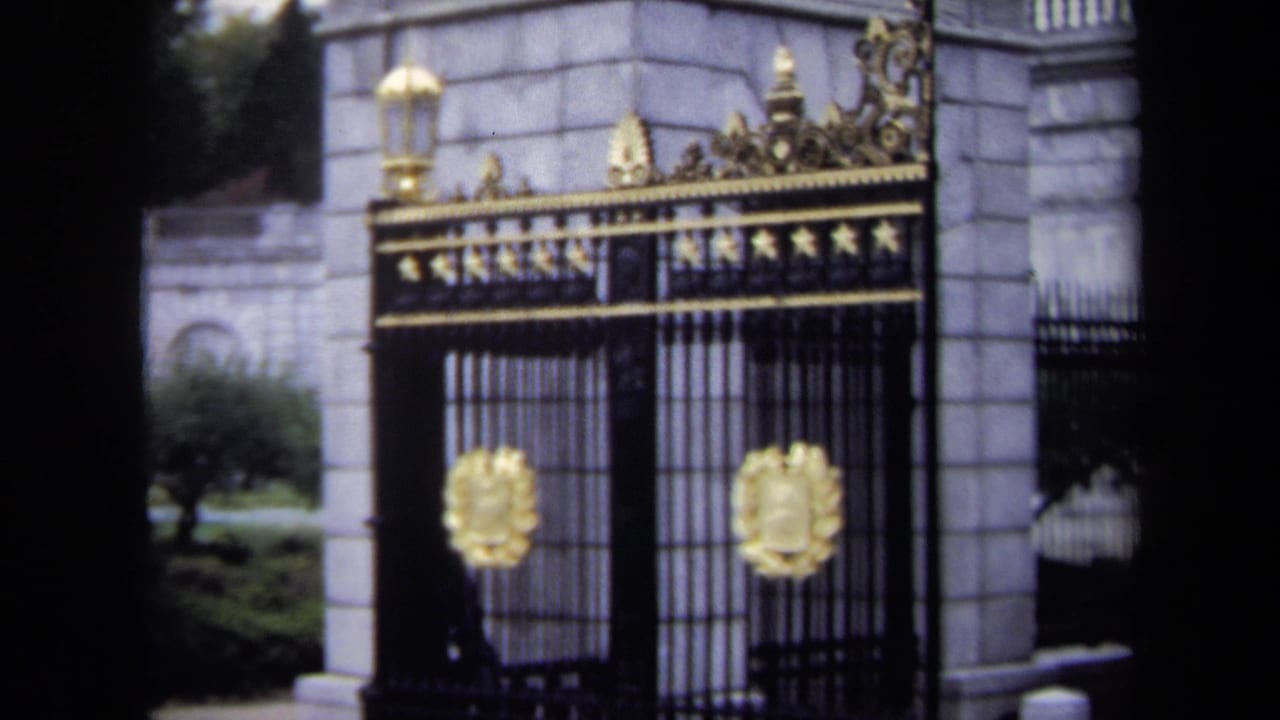 The 8mm frame moves closer to the Washington, DC gate, emphasizing gold crests, iron bars, and formal stone architecture.